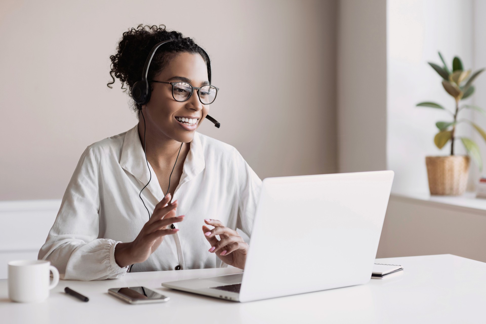 Woman wearing headset have meeting online, video conferencing